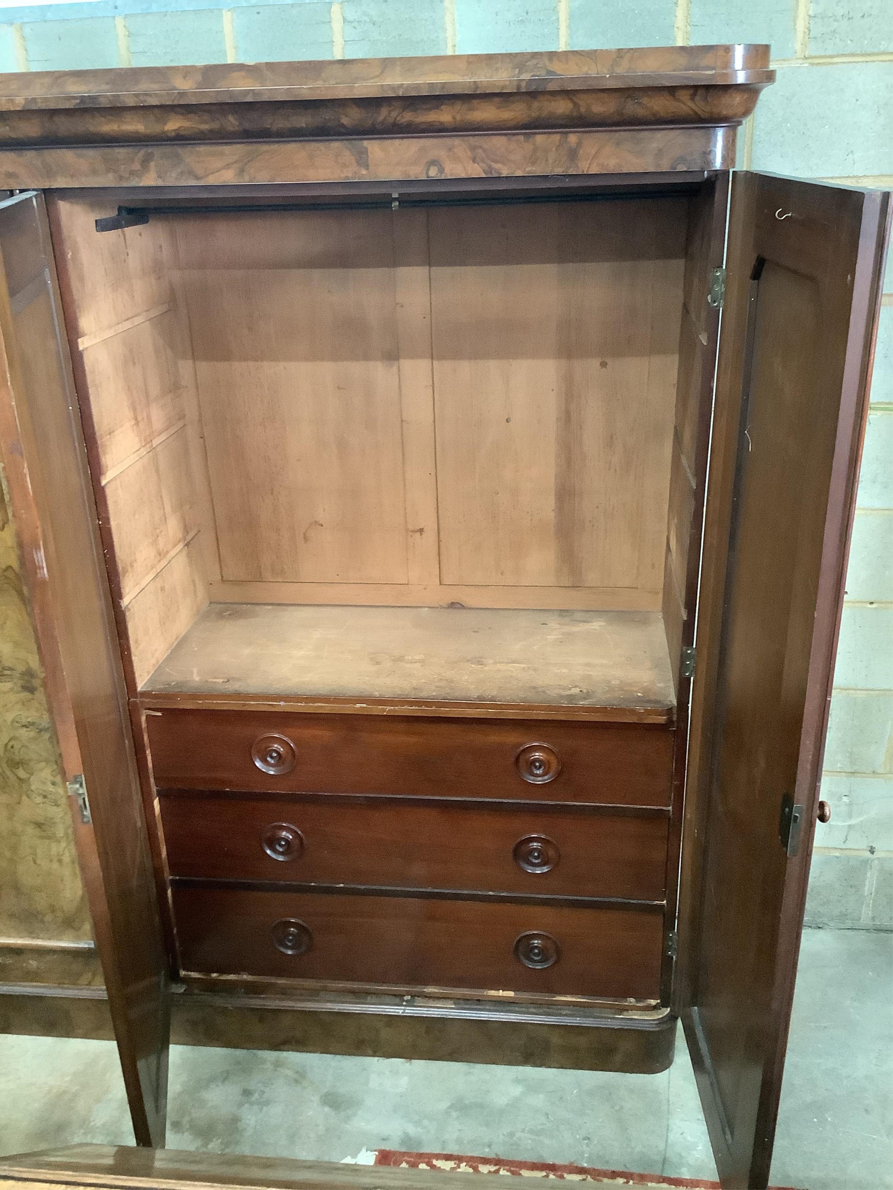 A Victorian figured walnut mirrored compactum wardrobe, width 192cm, depth 49cm, height 208cm. Condition - fair